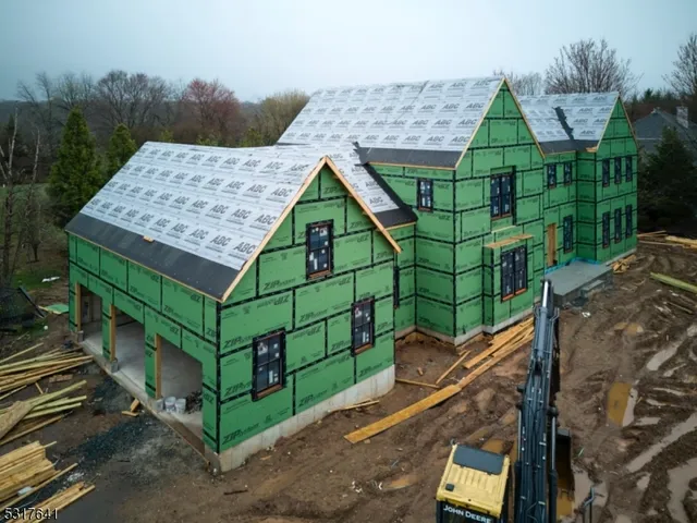 a green field with lots of trees in the background