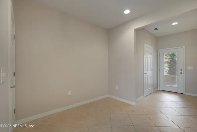a kitchen with a refrigerator and a stove top oven