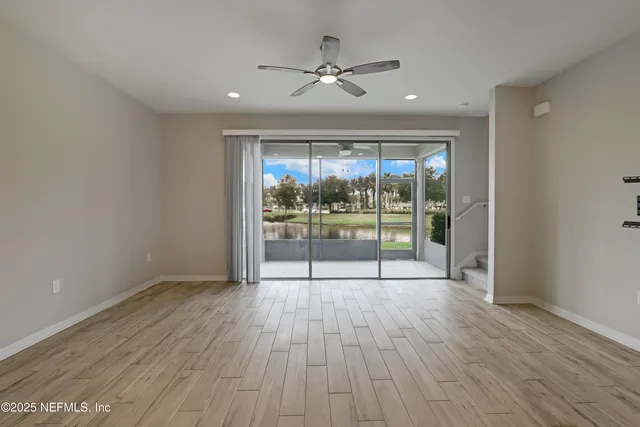 a view of kitchen with refrigerator microwave and cabinets