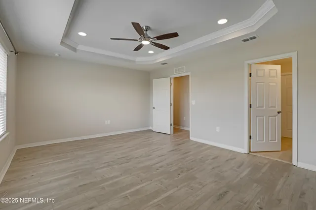 a bathroom with a granite countertop sink a toilet and a mirror