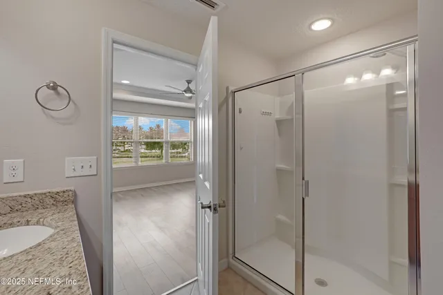 an empty room with a window and a fan