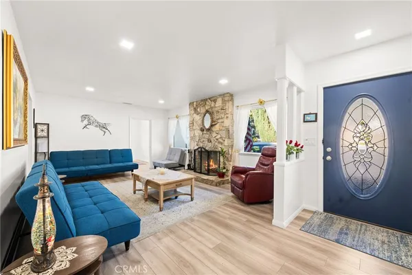 a living room with furniture a rug and a fireplace