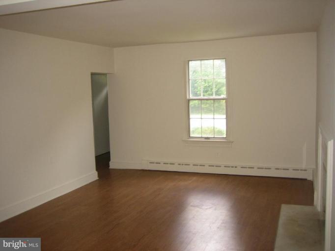 2115 Fairland Road Silver Spring, MD 20904 - Photo 7 of 16 an empty room with wooden floor and windows