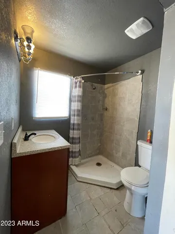 a view of a kitchen with stainless steel appliances granite countertop a sink and a stove
