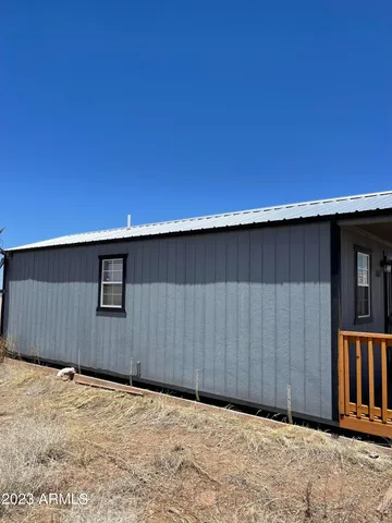a backyard of a house with wooden fence