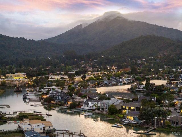 a view of a town with mountains in the background