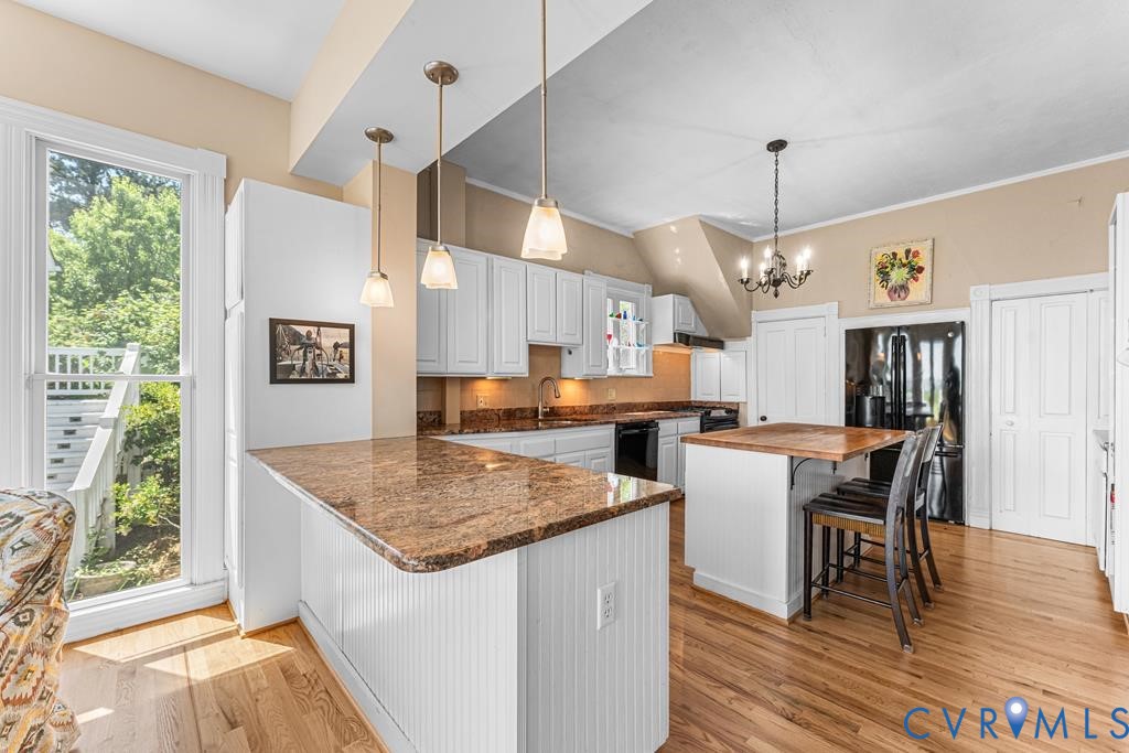 2414 Windmill Point Road White Stone, VA 22578 - Photo 20 of 72 a kitchen with stainless steel appliances granite countertop a stove oven a dining table and chairs with wooden floor