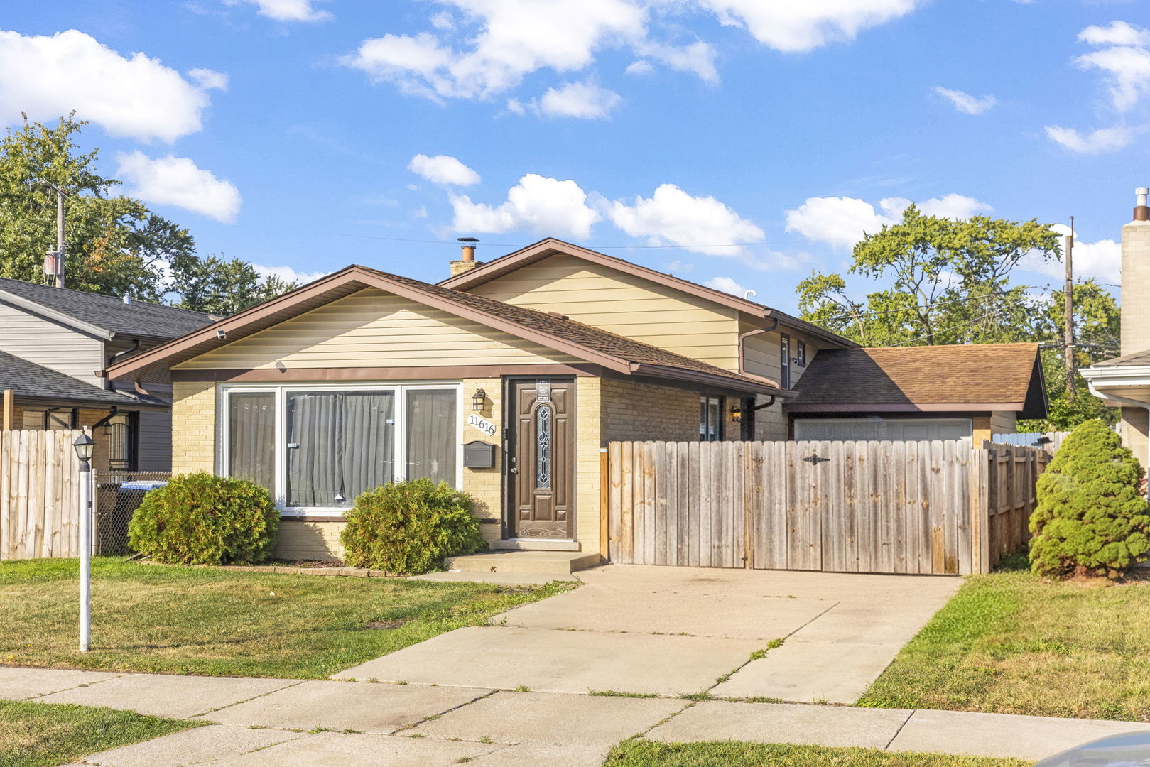 a front view of a house with a garden