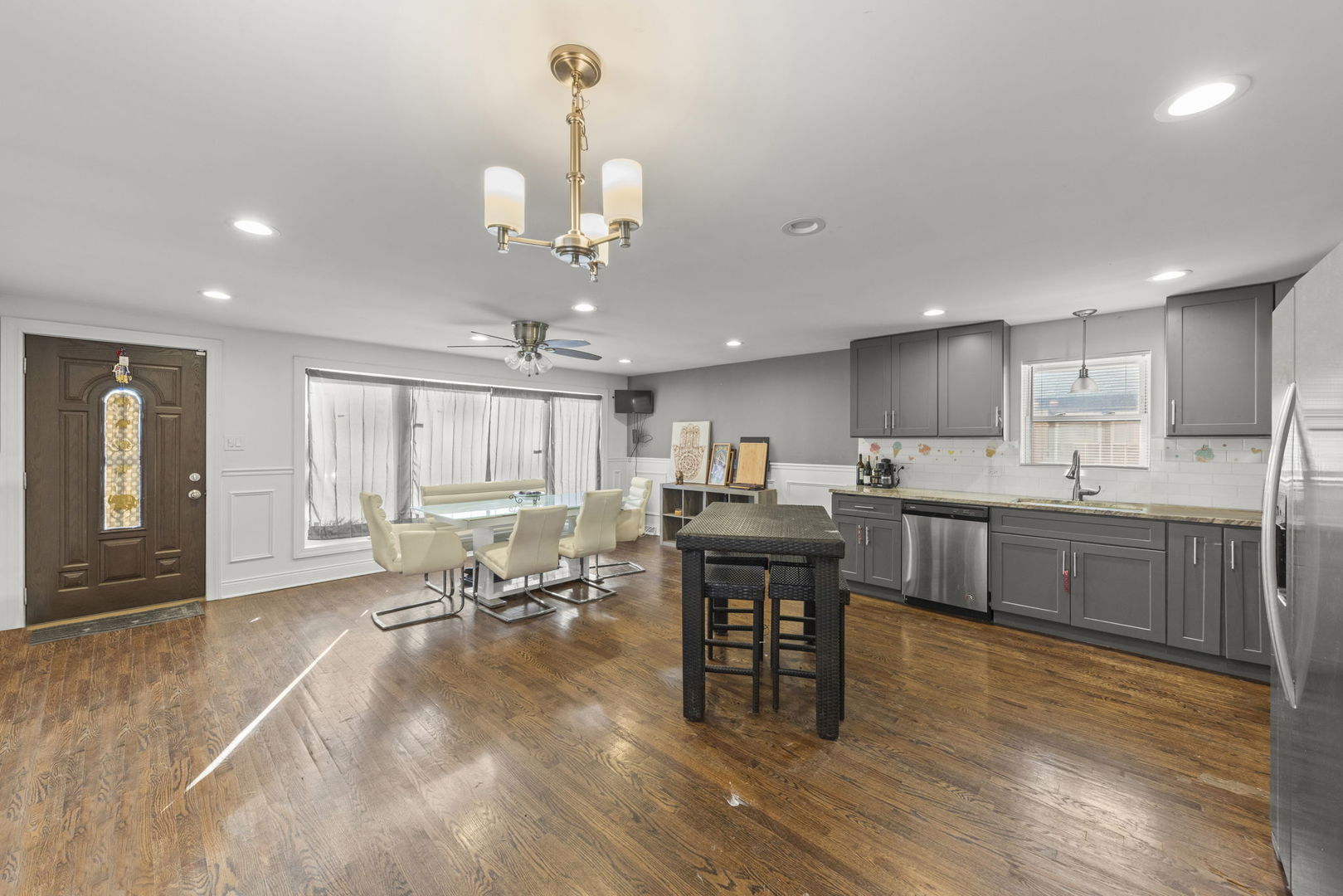 11616 South Racine Avenue Chicago, IL 60643 - Photo 4 of 13 a open kitchen with stainless steel appliances granite countertop a sink dining table and chairs