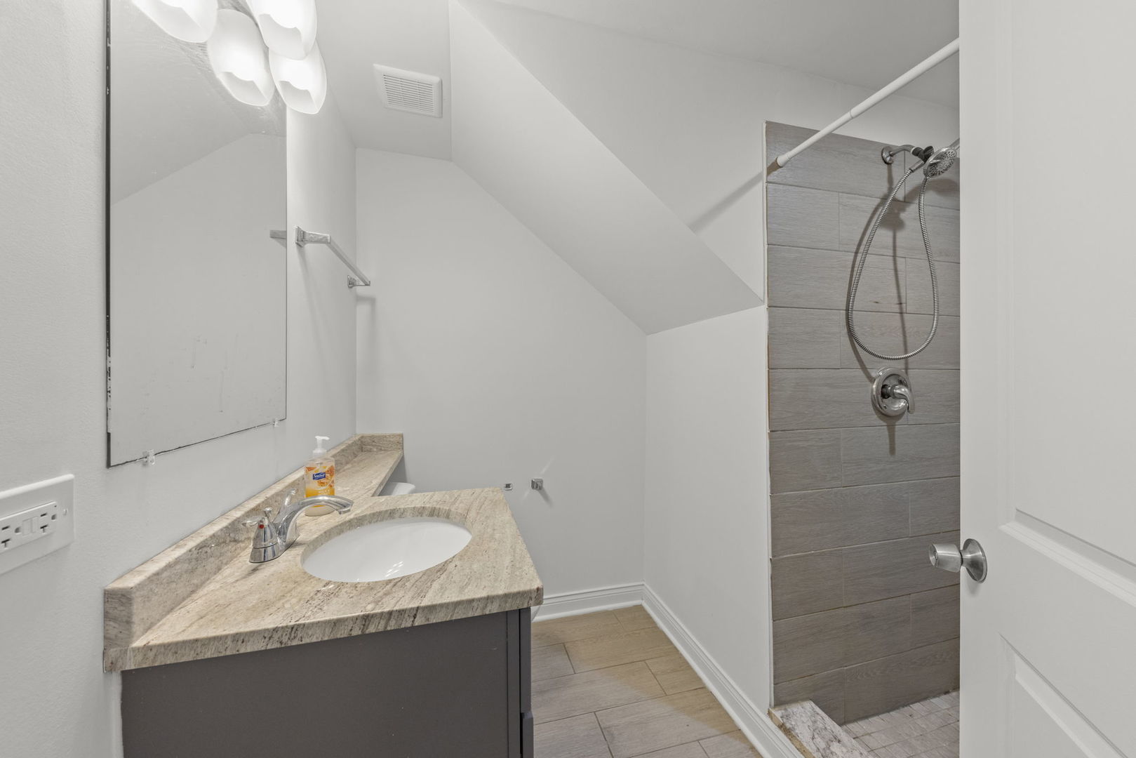 11616 South Racine Avenue Chicago, IL 60643 - Photo 6 of 13 a bathroom with a granite countertop sink a shower and a mirror