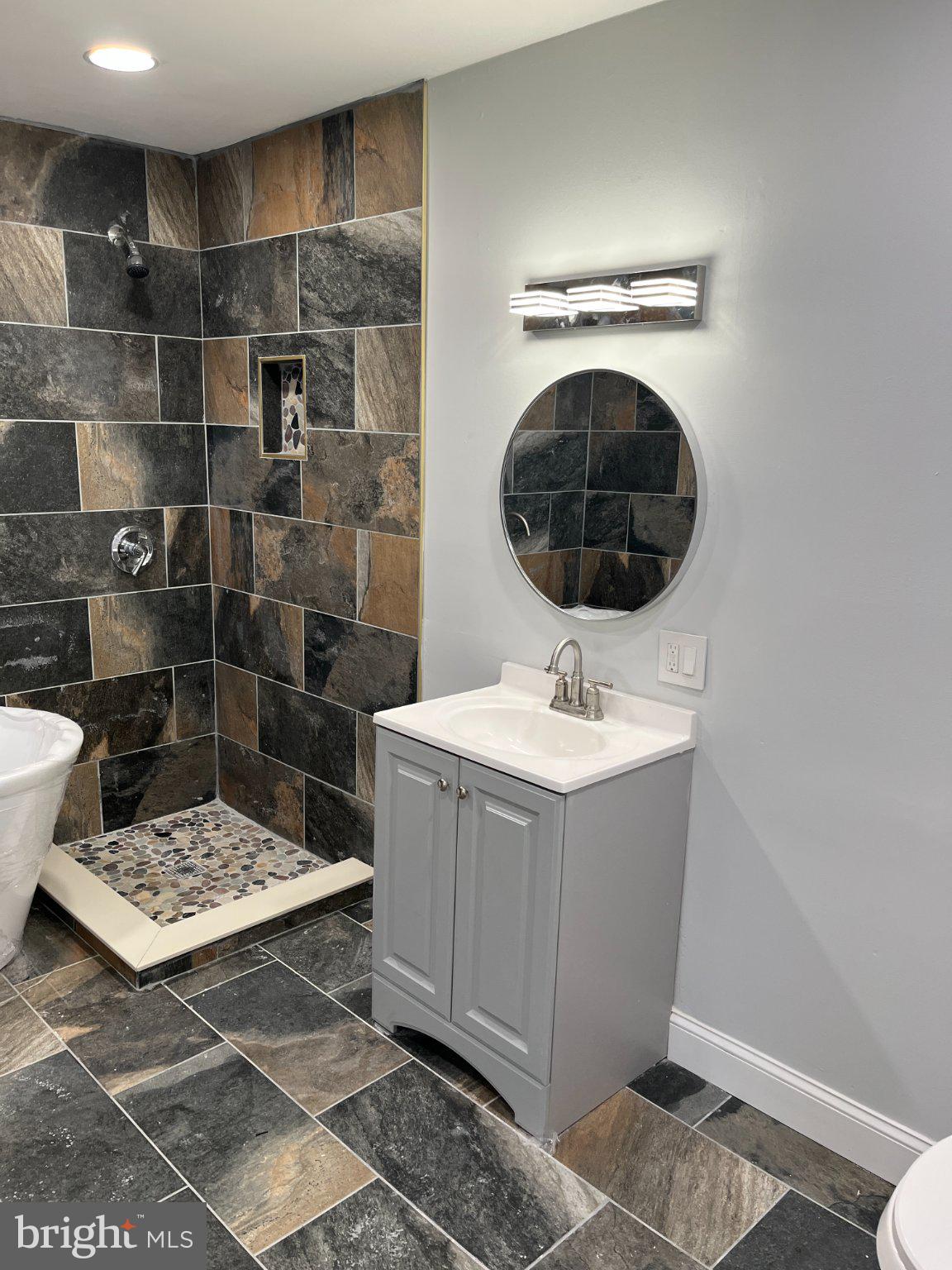2405 Limestone Road Wilmington, DE 19808 - Photo 31 of 40 a bathroom with a sink a toilet and shower