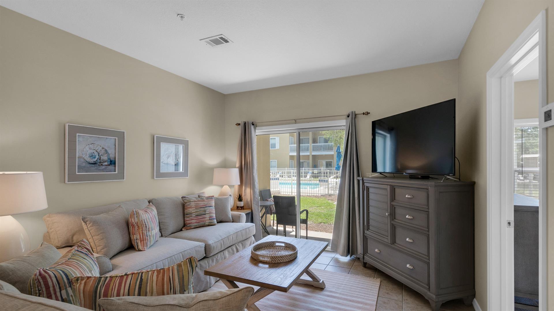 a living room with furniture and a flat screen tv