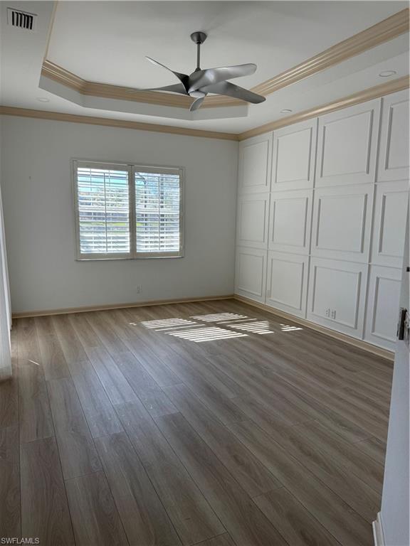 15890 Delasol Lane Naples, FL 34110 - Photo 13 of 16 a view of an empty room with wooden floor and a window