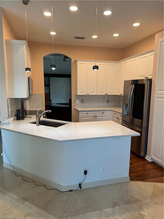 15890 Delasol Lane Naples, FL 34110 - Photo 6 of 16 a view of kitchen with stainless steel appliances a sink a refrigerator and a stove