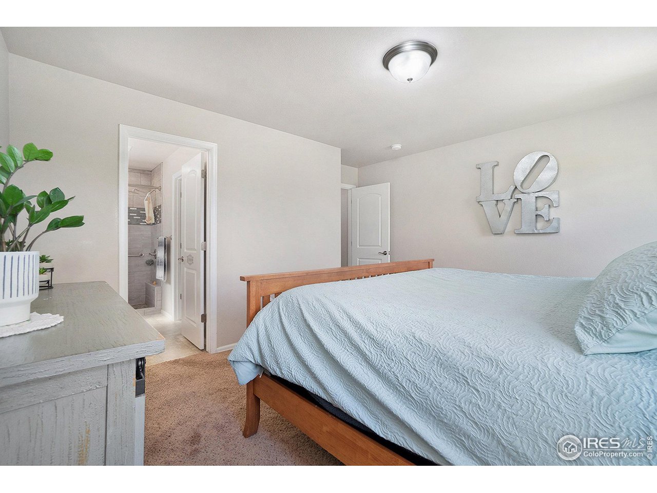 2185 Grain Bin Windsor, CO 80550 - Photo 13 of 22 a bedroom with a bed and a table