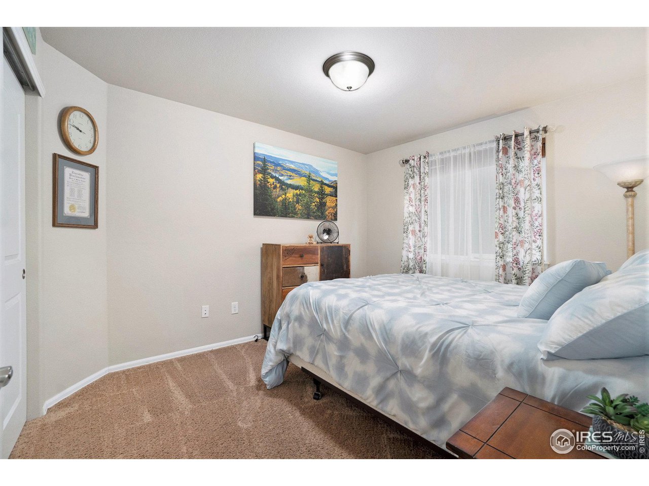 2185 Grain Bin Windsor, CO 80550 - Photo 15 of 22 a bedroom with a bed and a painting on the wall