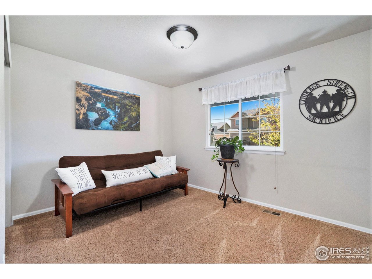 2185 Grain Bin Windsor, CO 80550 - Photo 16 of 22 a living room with furniture and a potted plant