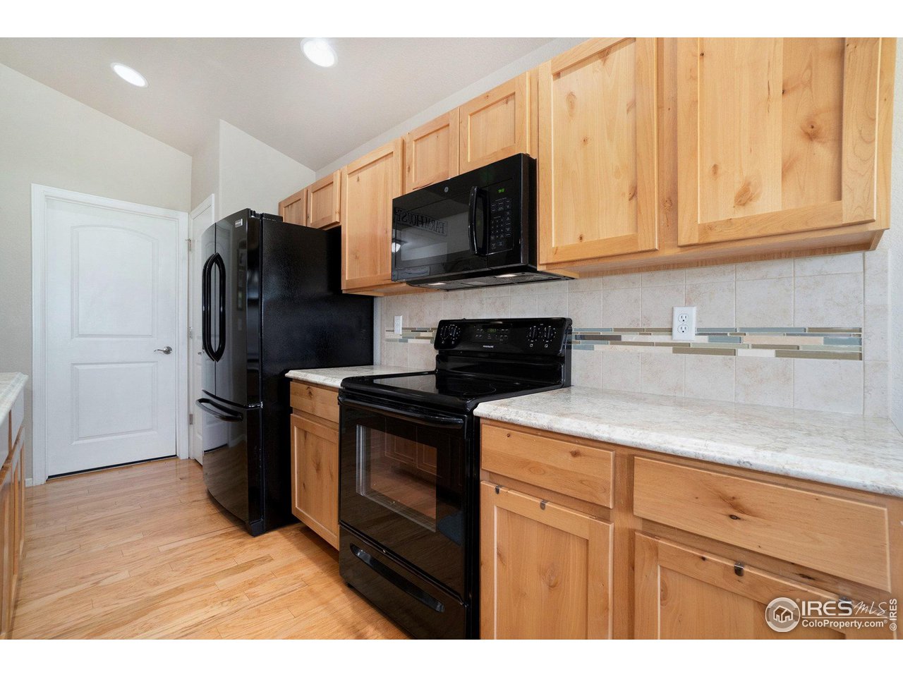 2185 Grain Bin Windsor, CO 80550 - Photo 6 of 22 a kitchen with stainless steel appliances granite countertop a refrigerator stove top oven a sink and dishwasher