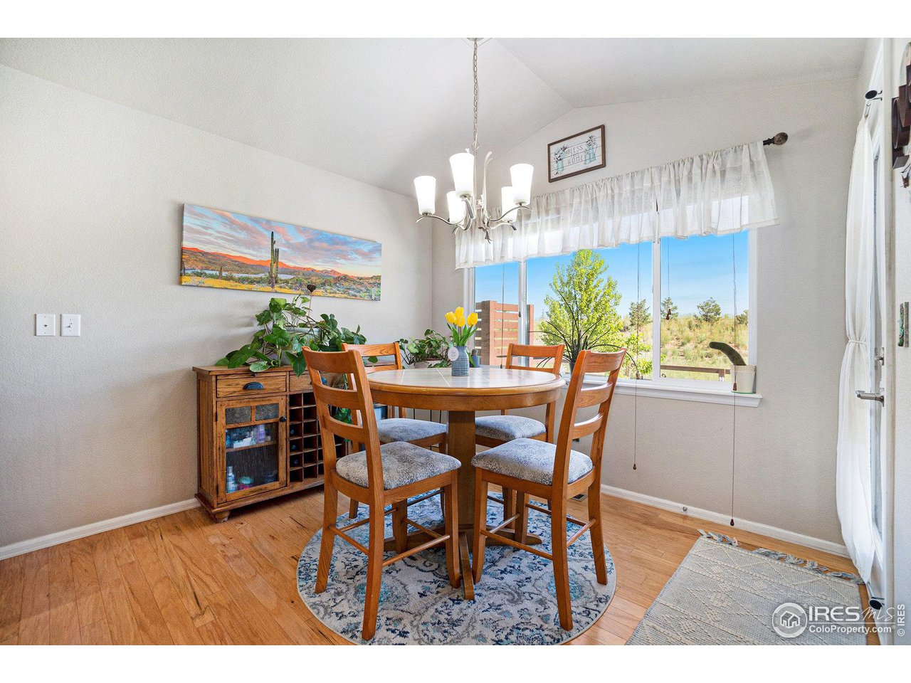 2185 Grain Bin Windsor, CO 80550 - Photo 7 of 22 a view of a dining room with furniture and chandelier