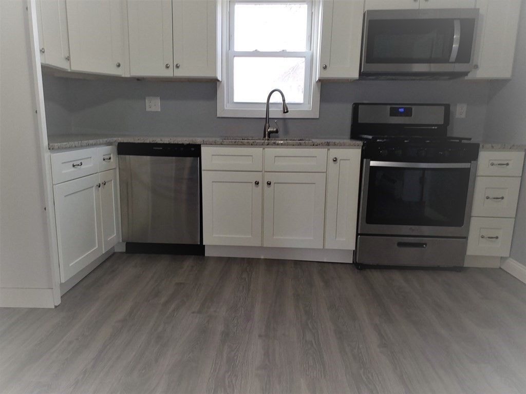 16 Court Street Lowell, MA 01852 - Photo 2 of 14 a kitchen with sink cabinets and window