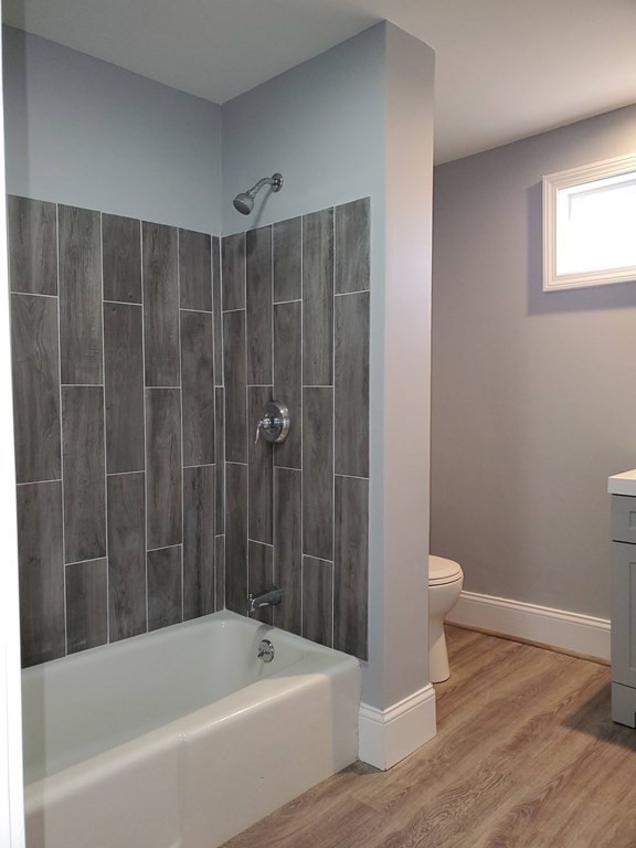 16 Court Street Lowell, MA 01852 - Photo 6 of 14 a bathroom with a bathtub and a toilet