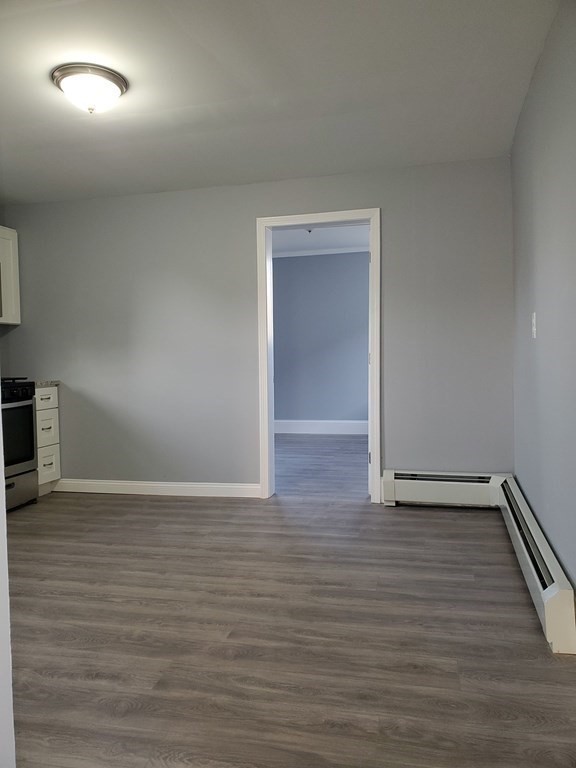16 Court Street Lowell, MA 01852 - Photo 8 of 14 a view of an empty room and wooden floor
