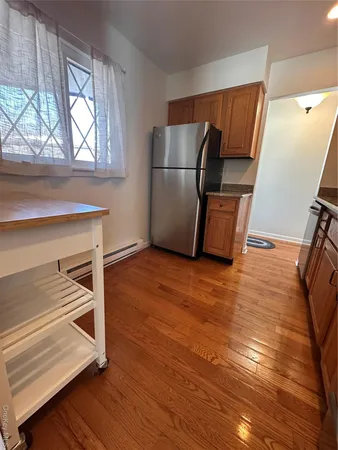 a room with wooden floor and windows