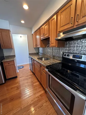 a kitchen with stainless steel appliances granite countertop a stove and a sink