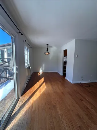 a view of a room with wooden floor
