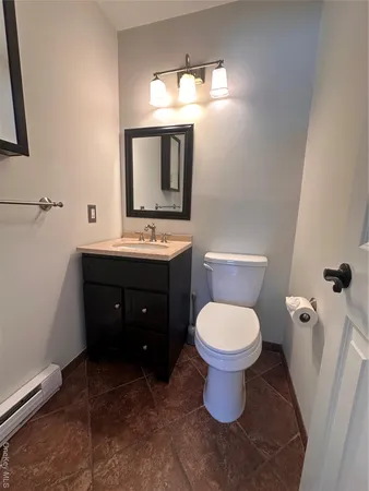 a bathroom with a toilet sink and mirror