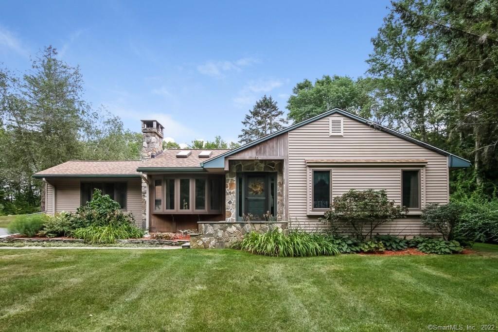 a front view of house with yard and green space
