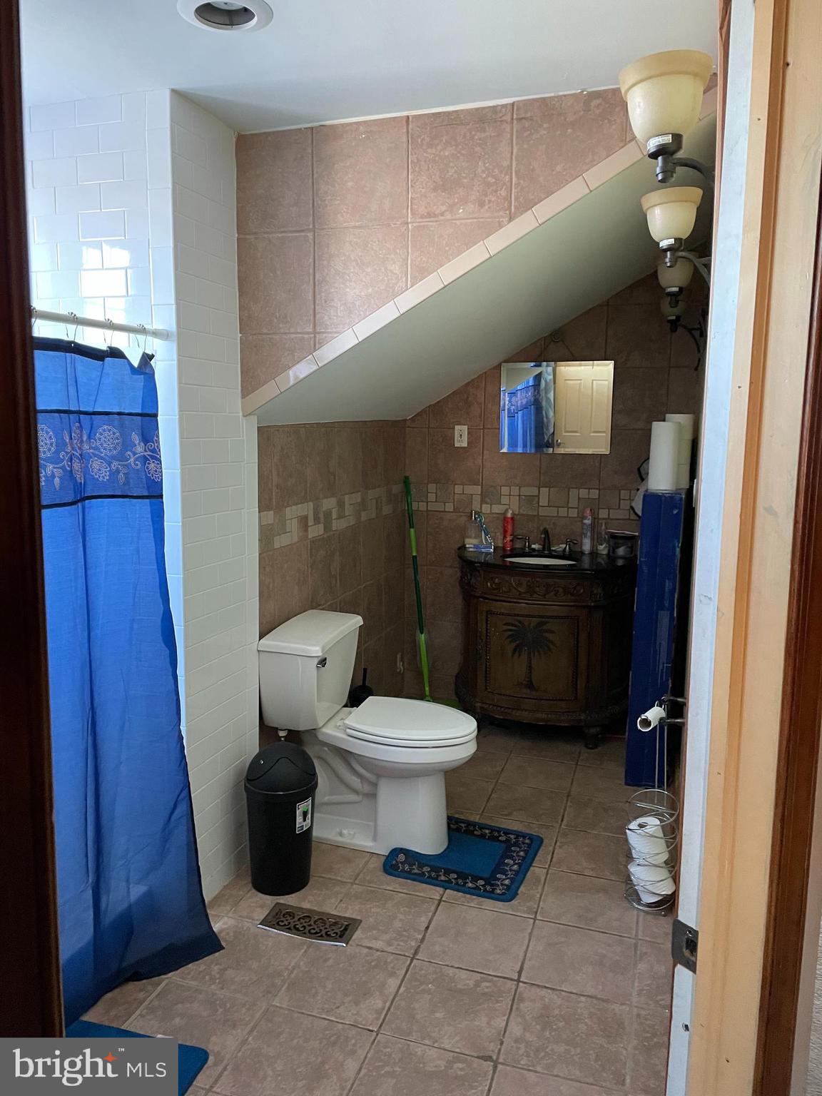 60 East Browning Road Bellmawr, NJ 08031 - Photo 10 of 13 a bathroom with a toilet a sink and a mirror
