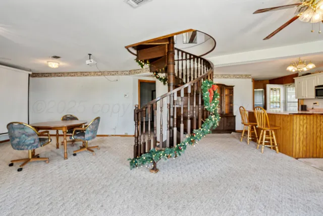 a view of a livingroom with furniture and a gym
