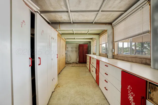 a large room with wooden floor and windows