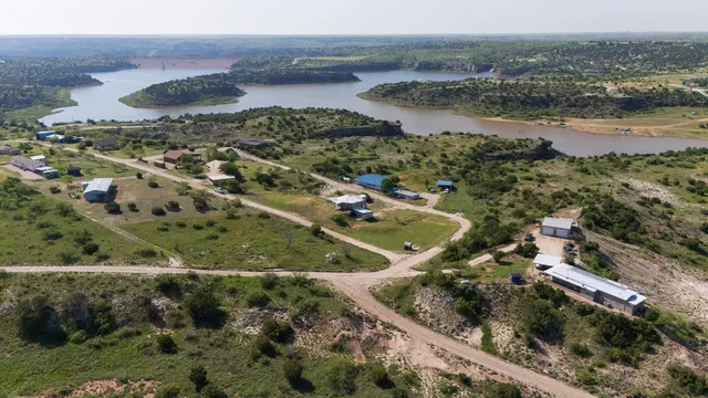 an aerial view of residential houses with outdoor space and river
