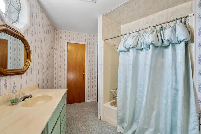 a bathroom with a sink and a mirror