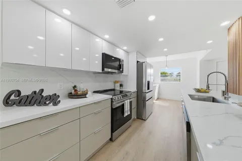 a kitchen with a sink a stove and cabinets