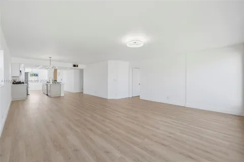 a view of a room with wooden floor and windows