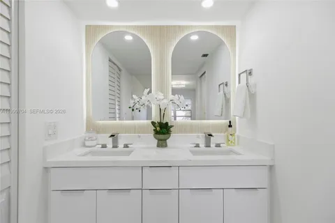 a bathroom with a double vanity sink mirror and double