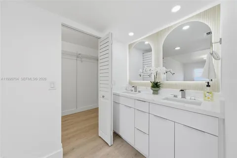 a bathroom with a double vanity sink mirror and shower