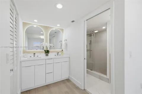 a bathroom with a granite countertop toilet and a shower