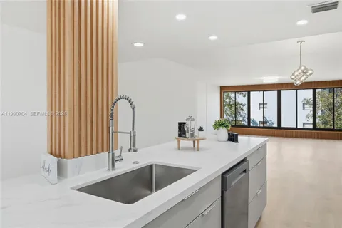 a kitchen with a sink and a large window