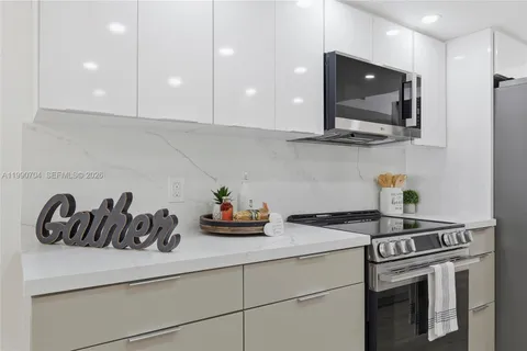 a kitchen with a stove a microwave and cabinets