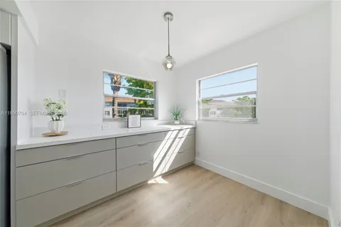a bathroom with a double vanity sink and a window