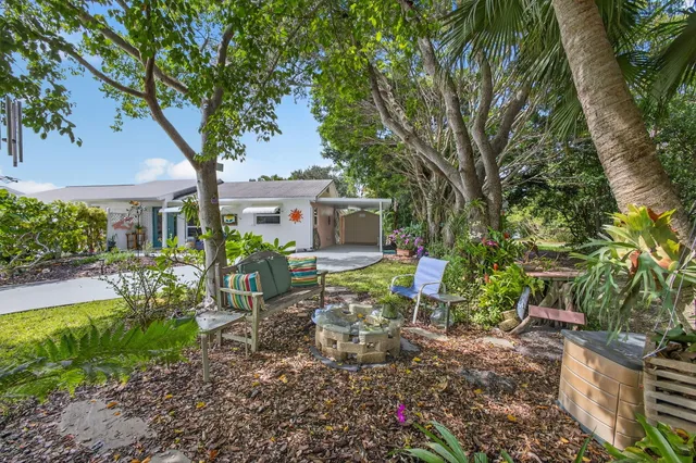 a view of a backyard with sitting area