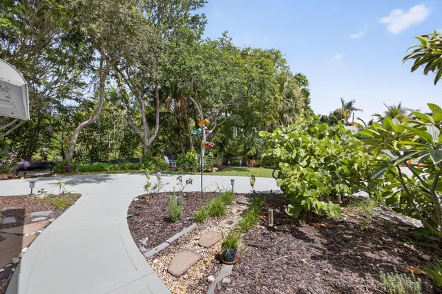 an aerial view of a house with a garden and lake view