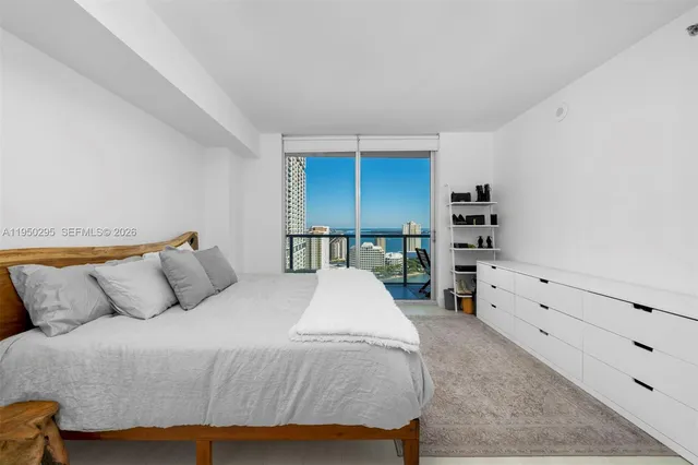 a bed sitting in a bedroom and dresser