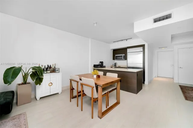 a kitchen with a stove a refrigerator and a sink