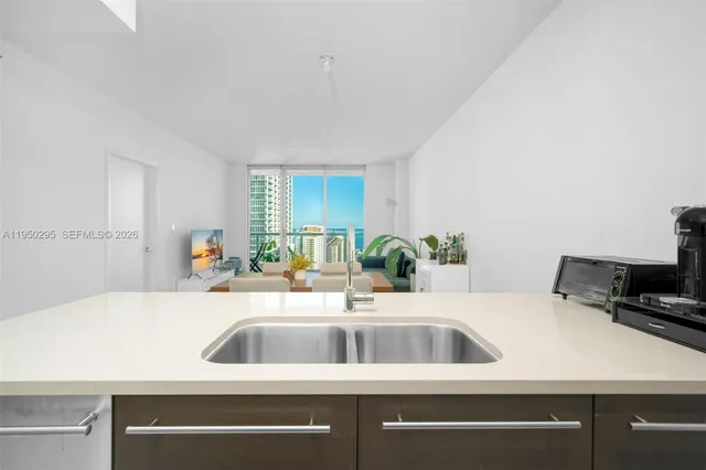 a view with a sink and a refrigerator