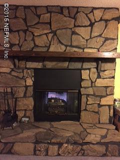 8236 Brooks Road Bryceville, FL 32009 - Photo 16 of 26 a fireplace with a wooden floor